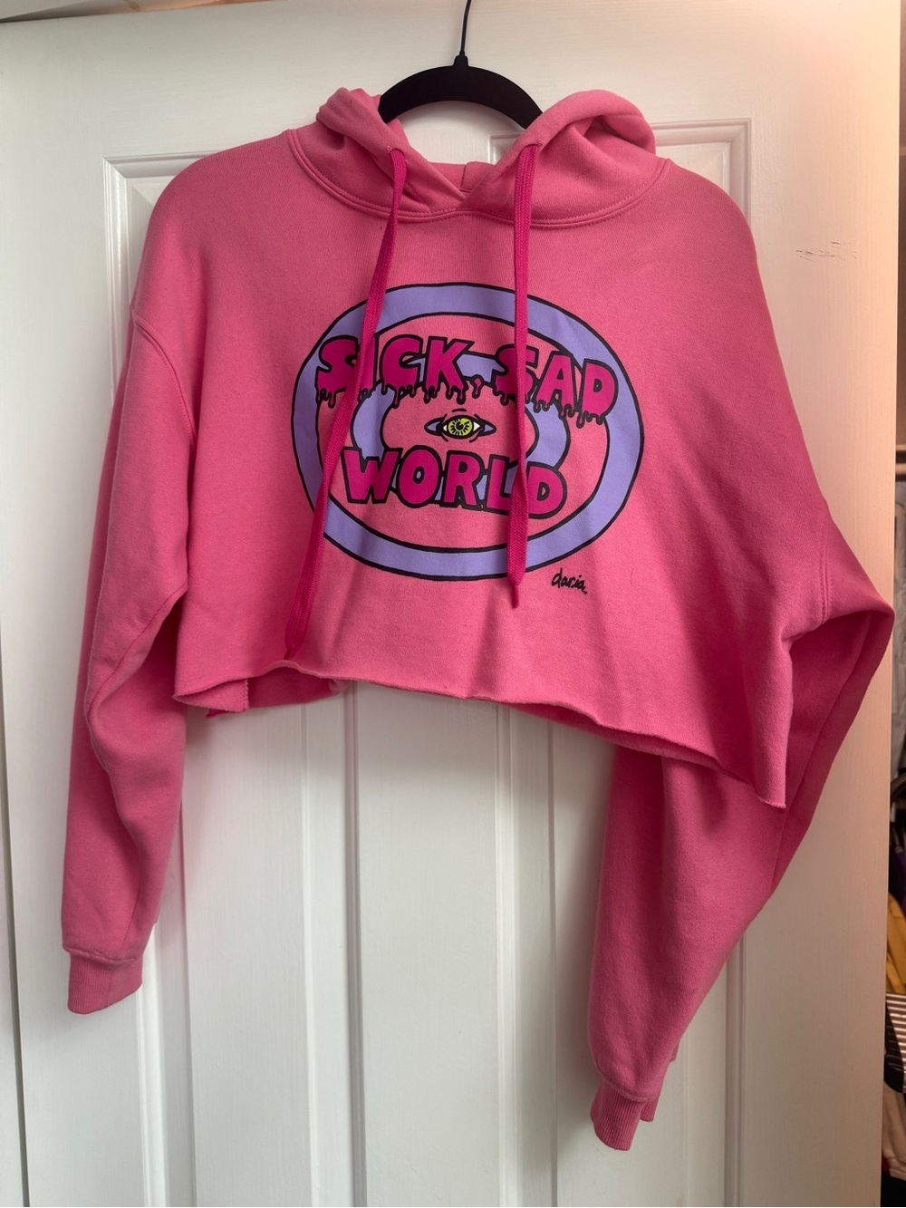 Daria Pink Cropped Graphic Hoodie with 'Sick Sad World' Print